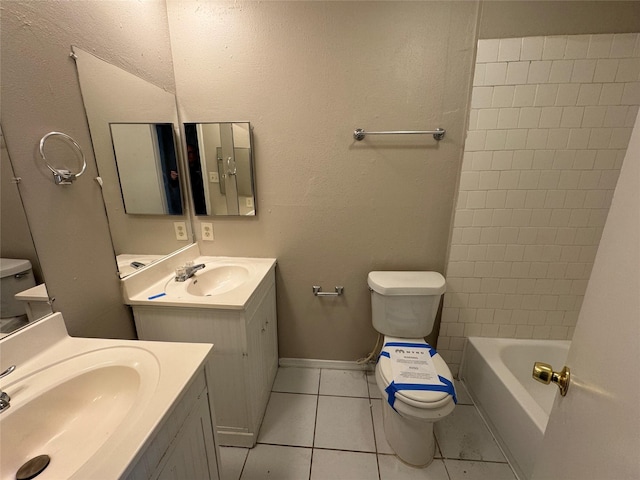 bathroom featuring toilet, vanity, and tile patterned floors