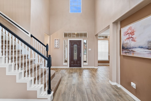 foyer entrance with a towering ceiling