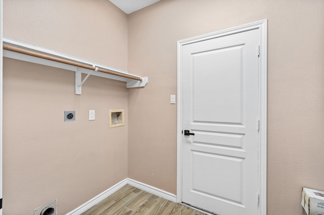 clothes washing area featuring hookup for an electric dryer, light hardwood / wood-style floors, and washer hookup