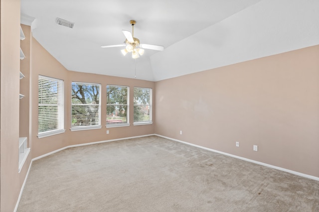 unfurnished room with ceiling fan, light colored carpet, and lofted ceiling