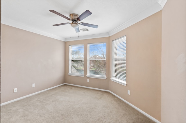 carpeted spare room featuring ceiling fan and crown molding