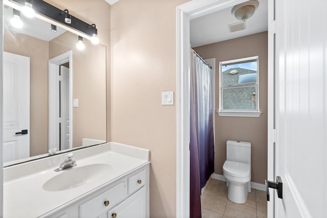 bathroom with tile patterned floors, vanity, and toilet