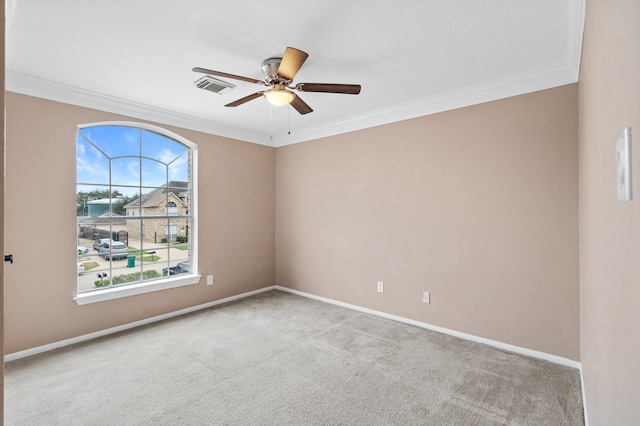 carpeted empty room featuring crown molding, ceiling fan, and a healthy amount of sunlight