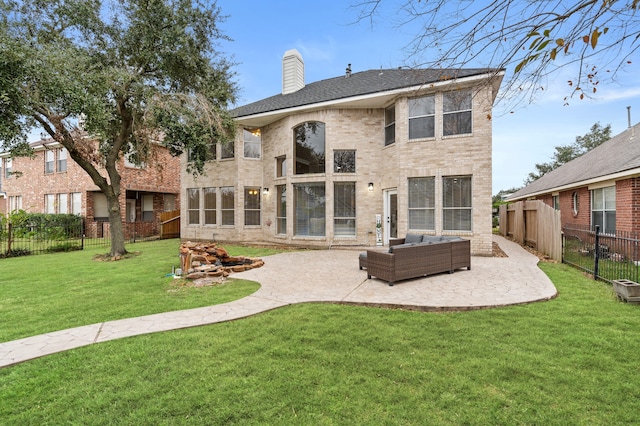 back of property featuring a yard, an outdoor hangout area, and a patio area