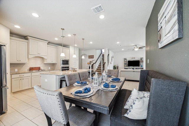 dining room with ceiling fan and light tile patterned flooring