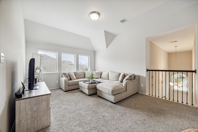 living room featuring light colored carpet and vaulted ceiling