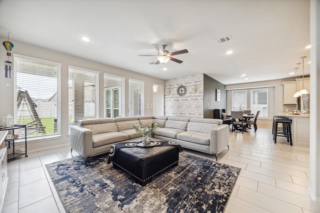 tiled living room with ceiling fan