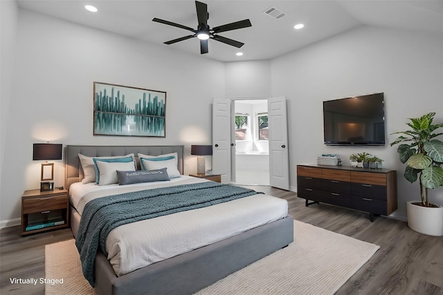 bedroom featuring connected bathroom, ceiling fan, and dark hardwood / wood-style flooring