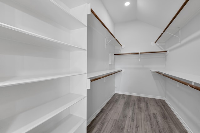 walk in closet with hardwood / wood-style floors and lofted ceiling