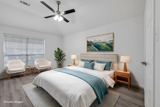 bedroom featuring ceiling fan, light hardwood / wood-style flooring, and vaulted ceiling