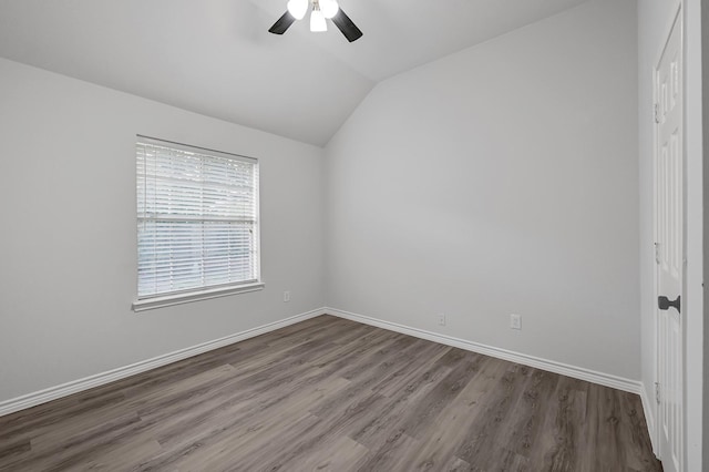 spare room featuring wood-type flooring, vaulted ceiling, and ceiling fan