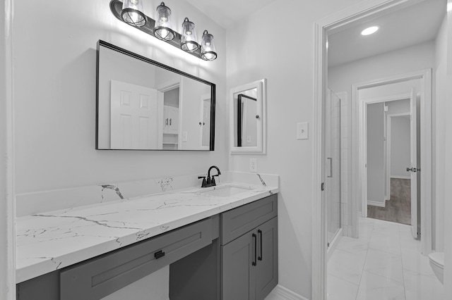 bathroom featuring a shower and vanity