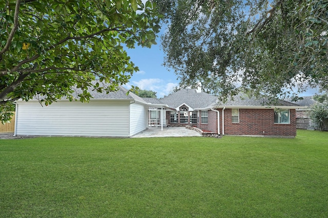 rear view of property with a patio area and a yard