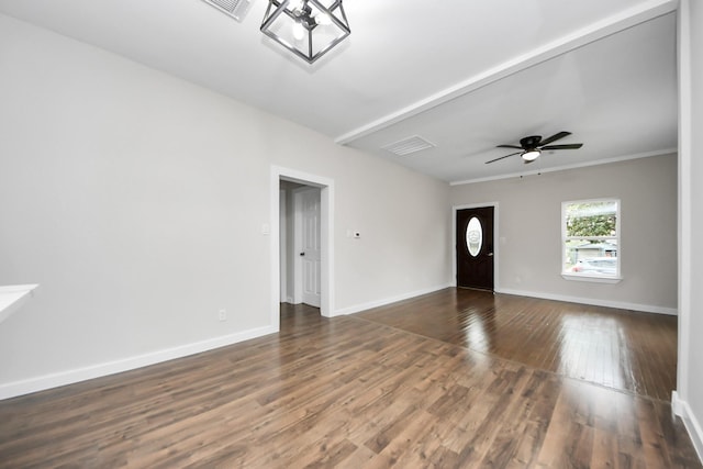 unfurnished living room featuring dark wood-type flooring and ceiling fan