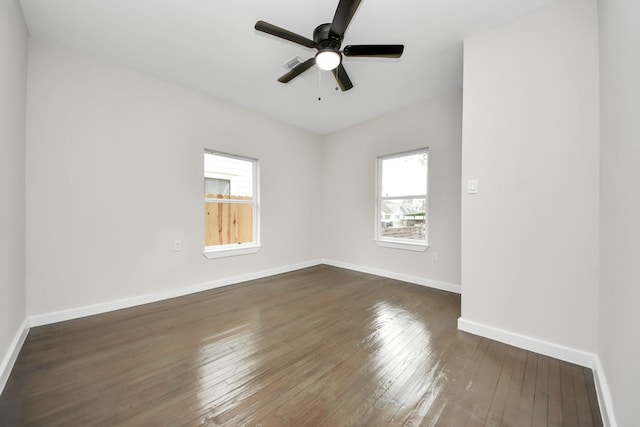 empty room featuring dark wood-type flooring and ceiling fan