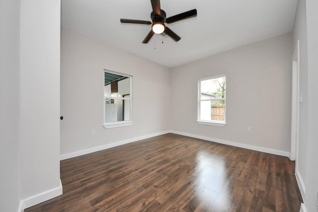 unfurnished room featuring dark wood-type flooring and ceiling fan