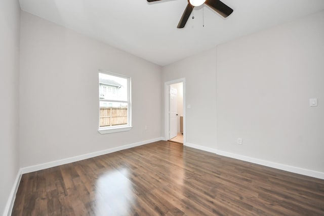 spare room with ceiling fan and dark hardwood / wood-style floors