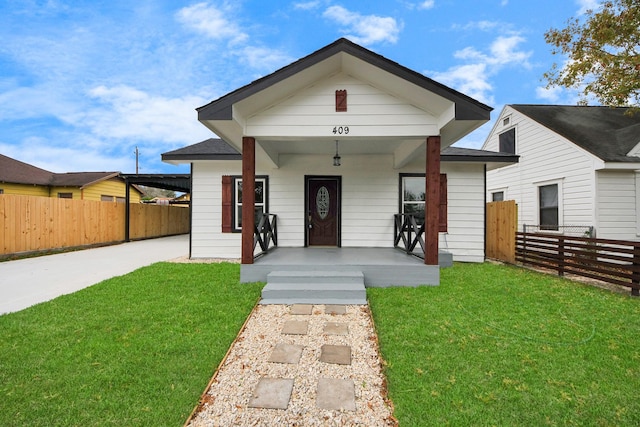 view of front of house featuring covered porch and a front lawn