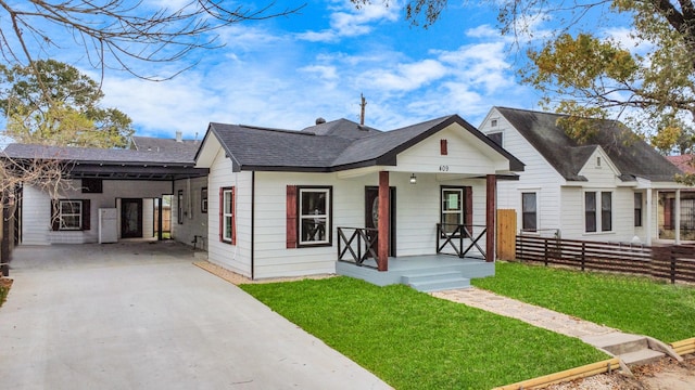 view of front of property with a carport, a front yard, and covered porch