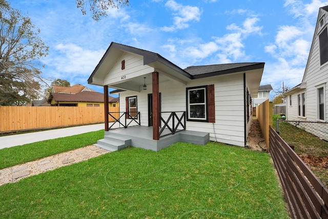 bungalow-style home featuring a porch and a front lawn