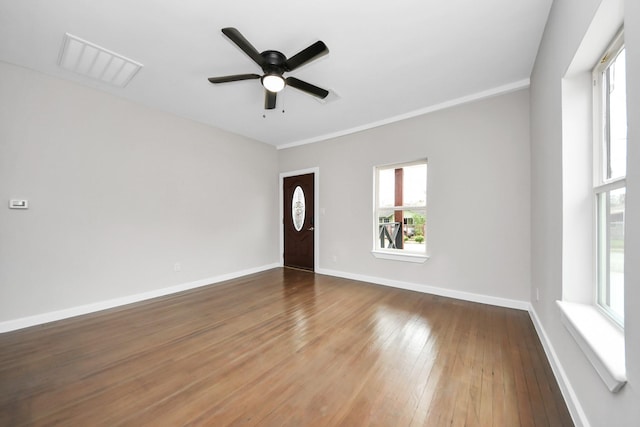 empty room with ceiling fan and hardwood / wood-style floors