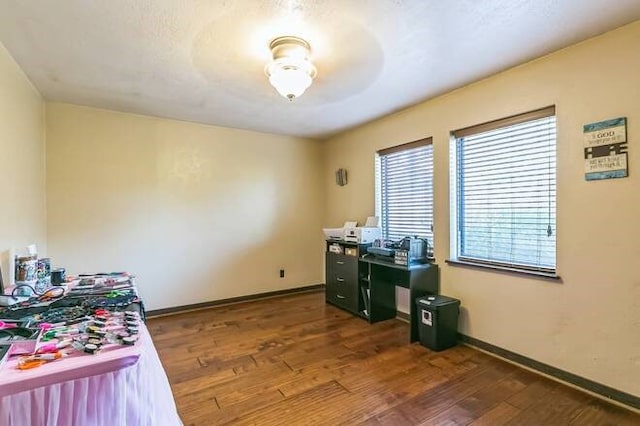 home office with dark hardwood / wood-style flooring