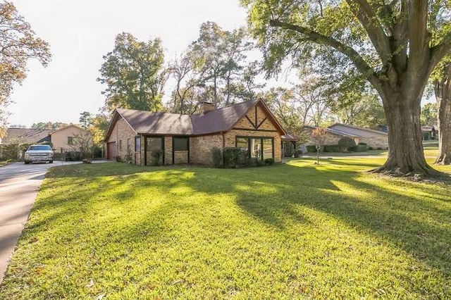 tudor house featuring a front lawn