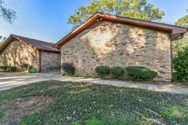 view of side of home featuring a yard