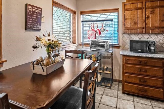 dining area featuring light tile patterned floors