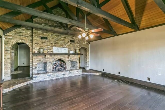 unfurnished living room featuring hardwood / wood-style floors, ceiling fan, beam ceiling, and a fireplace