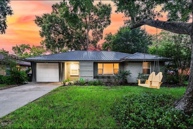 single story home with a yard and a garage