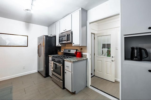 kitchen with white cabinetry and appliances with stainless steel finishes