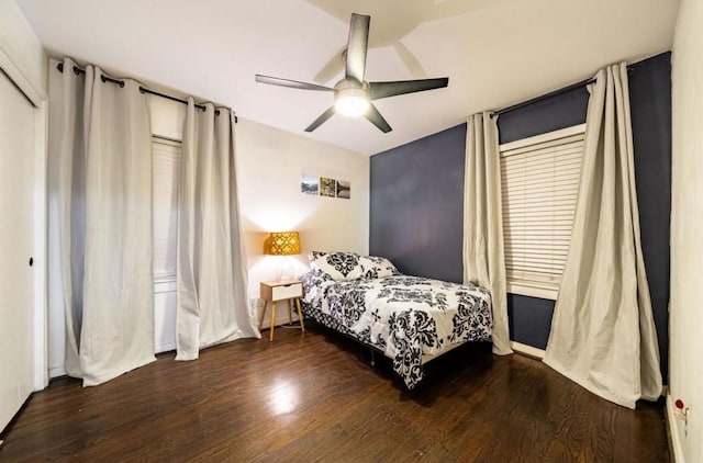 bedroom with dark hardwood / wood-style flooring and ceiling fan