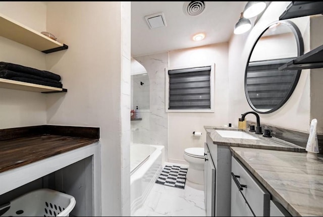 full bathroom with vanity, tiled shower / bath combo, and toilet