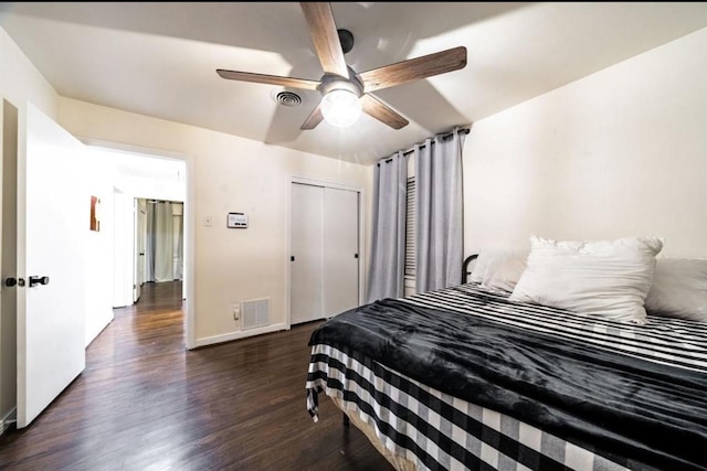 bedroom with ceiling fan, dark hardwood / wood-style floors, and a closet