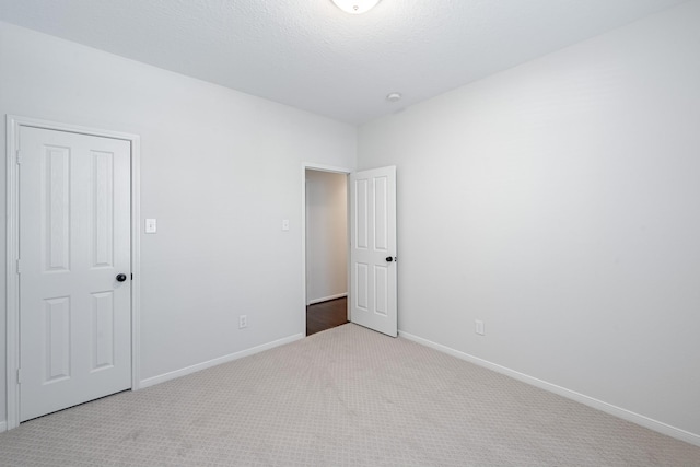 unfurnished bedroom featuring light colored carpet