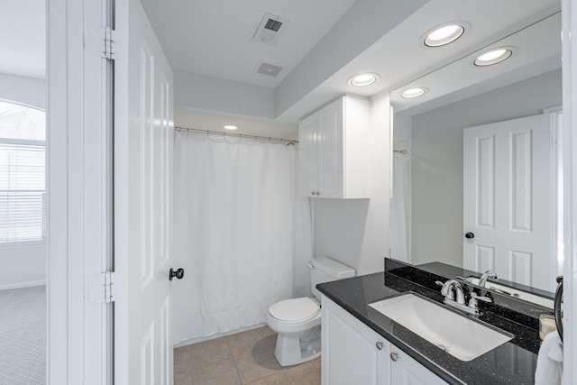 bathroom featuring tile patterned floors, plenty of natural light, toilet, and vanity