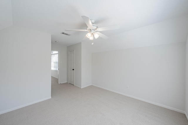 unfurnished room with vaulted ceiling, light carpet, and ceiling fan