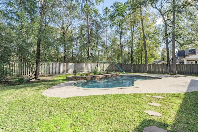 view of swimming pool featuring a yard and a playground