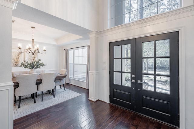 entrance foyer with plenty of natural light, dark hardwood / wood-style flooring, and french doors