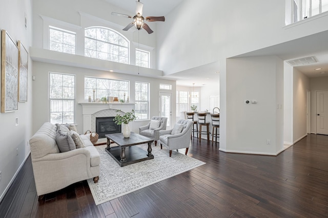 living room featuring dark hardwood / wood-style flooring and a high ceiling