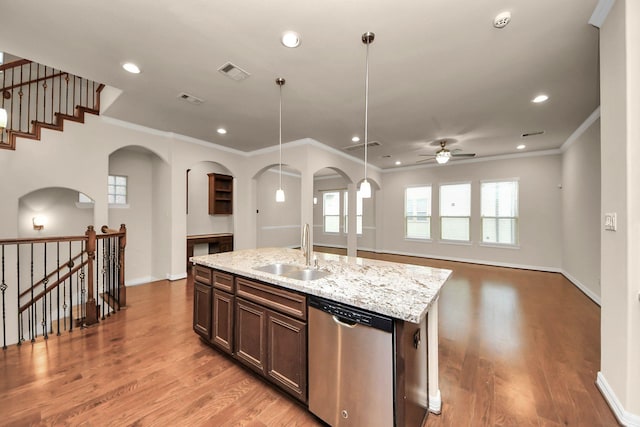 kitchen featuring ceiling fan, sink, stainless steel dishwasher, crown molding, and a center island with sink