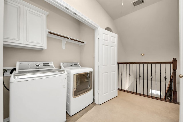 laundry area featuring cabinets and separate washer and dryer