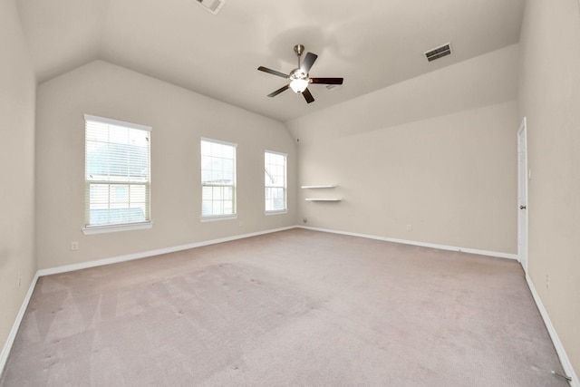 carpeted empty room featuring ceiling fan and lofted ceiling