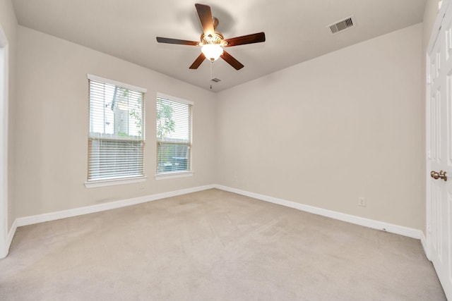 carpeted empty room featuring ceiling fan