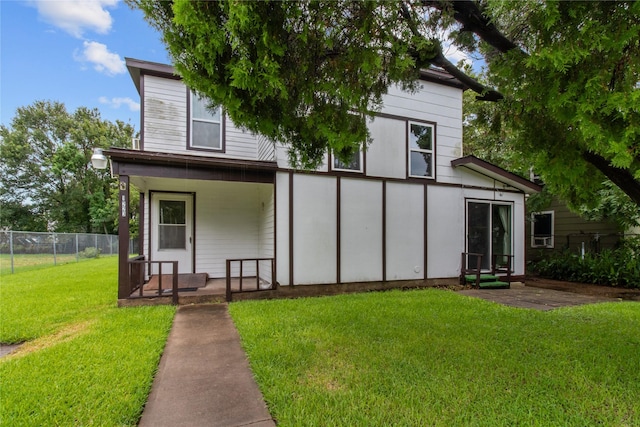 rear view of house with a yard