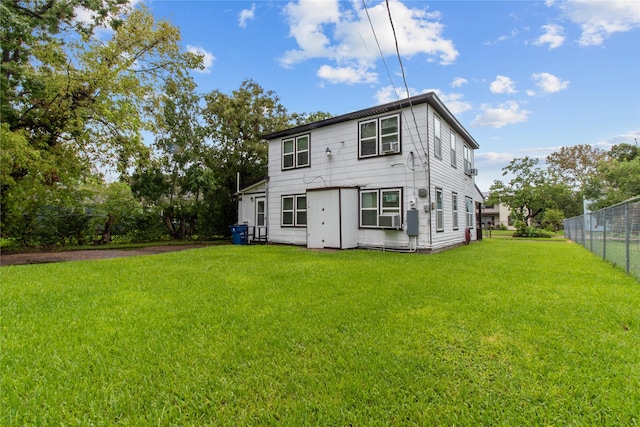 rear view of house featuring a yard