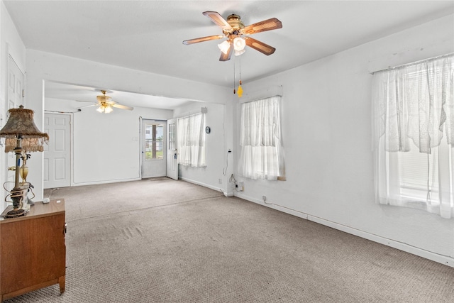 spare room featuring ceiling fan and light carpet