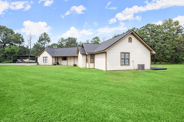 ranch-style house featuring central air condition unit and a front lawn