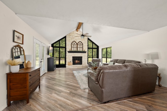 living room featuring a fireplace, ceiling fan, hardwood / wood-style floors, and lofted ceiling with beams